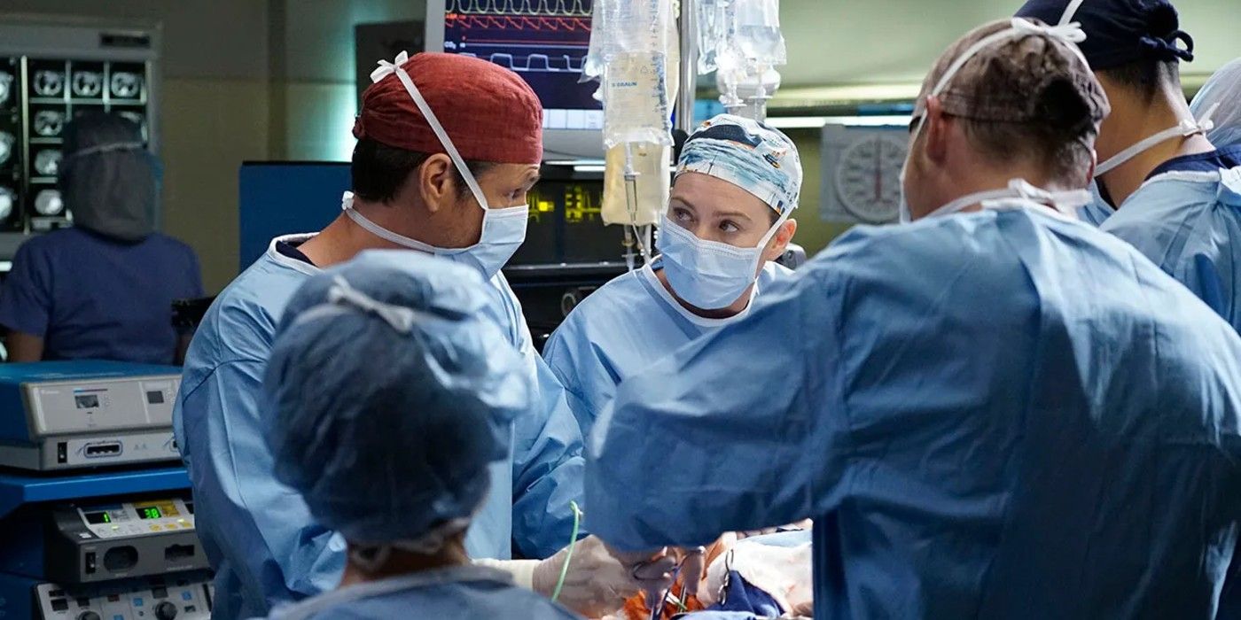 Meredith looks intently at Karev while in full surgical dress in the middle of a surgery in Grey's Anatomy.