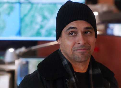 Nick Torres in a beanie smirking in NCIS season 22