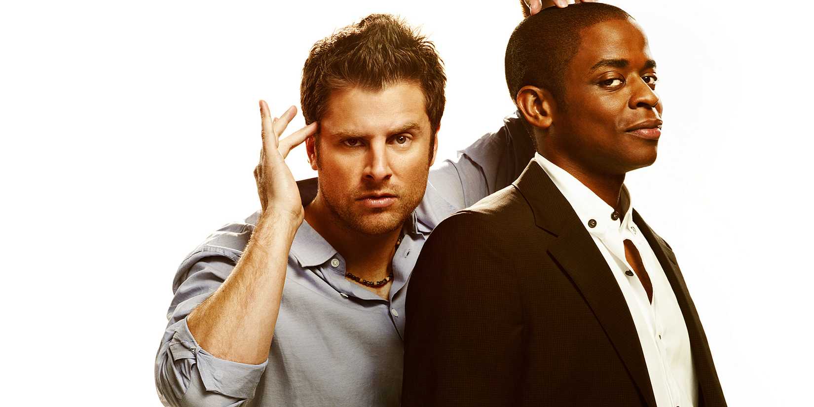 James Roday Rodriguez as Shawn putting a hand to his temples while leaning behind Dule Hill Gus in a Psych promo image