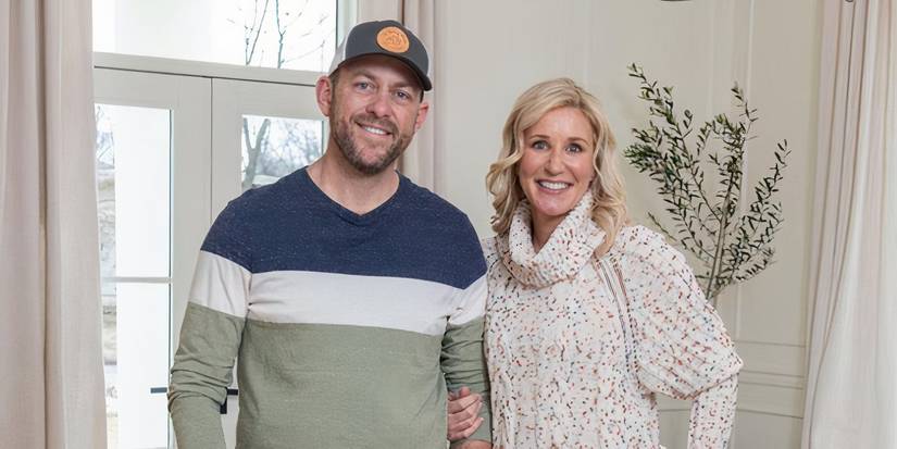 The Fixer to Fabulous couple in a front hallway smiling at the camera