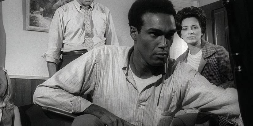 Man holding a gun on the night of the living dead