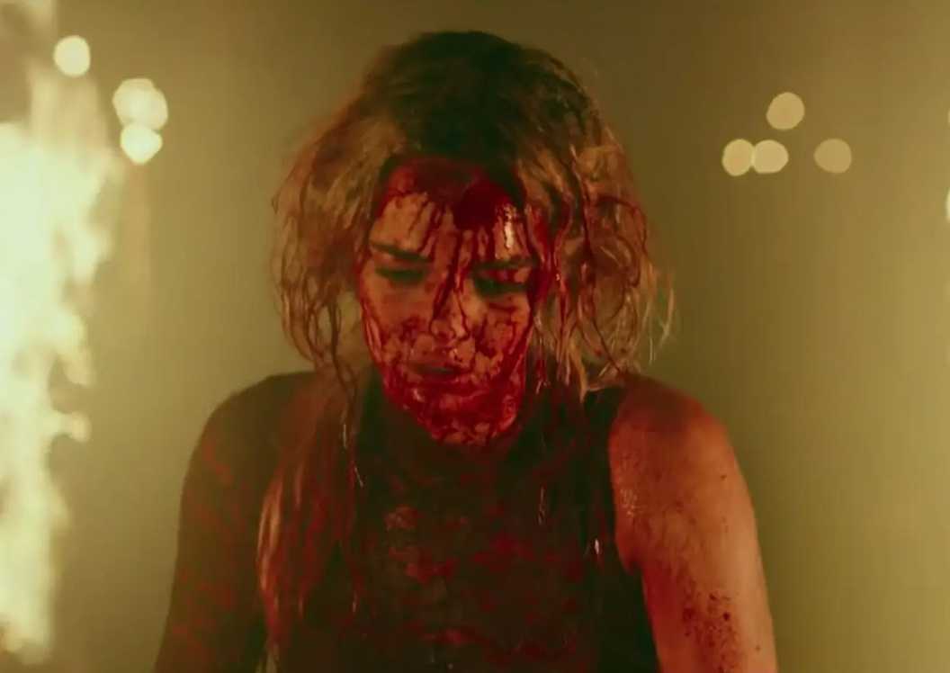 Samara Weaving as Grace walking through fire in Ready or Not