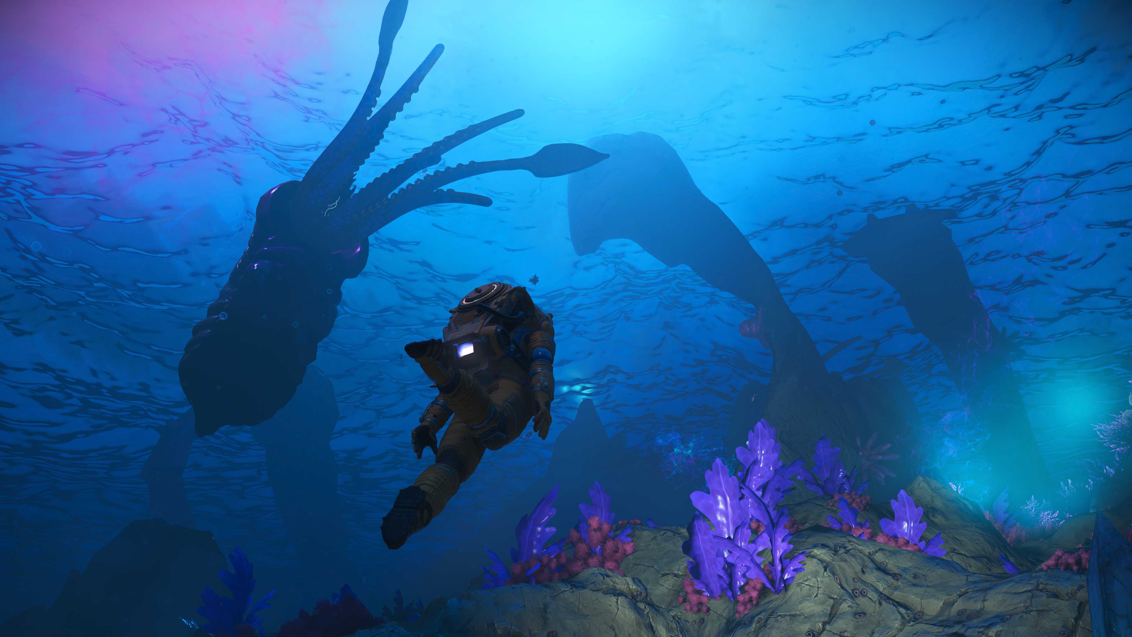 A player character swimming through the ocean, right next to a squidlike creature in the No Man's Sky Worlds Part 2 update.