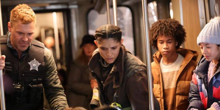 Adam-Ruzek-and-Stella-Kidd-with-Train-Passengers-in-One-Chicago-Crossover-2025