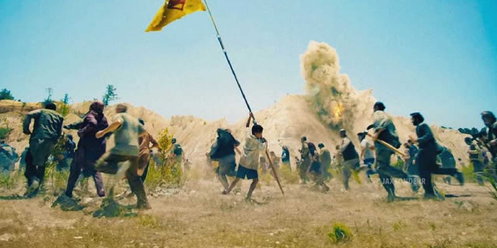 Boy lifts a flag in the Superman trailer