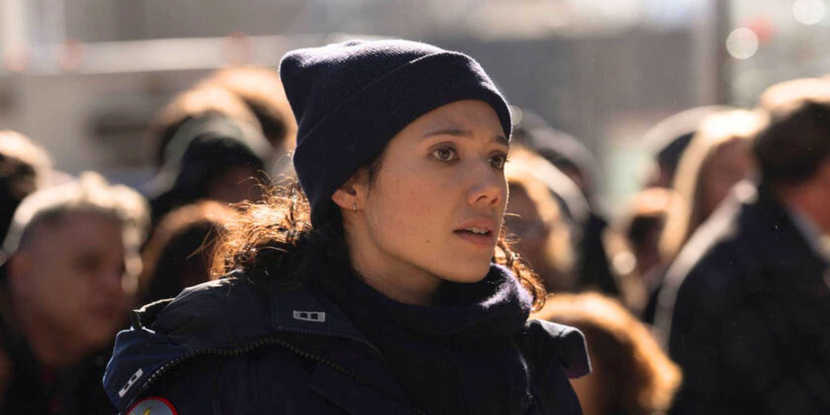 Chicago Fire Violet standing in a crowd of people staring at something off-camera