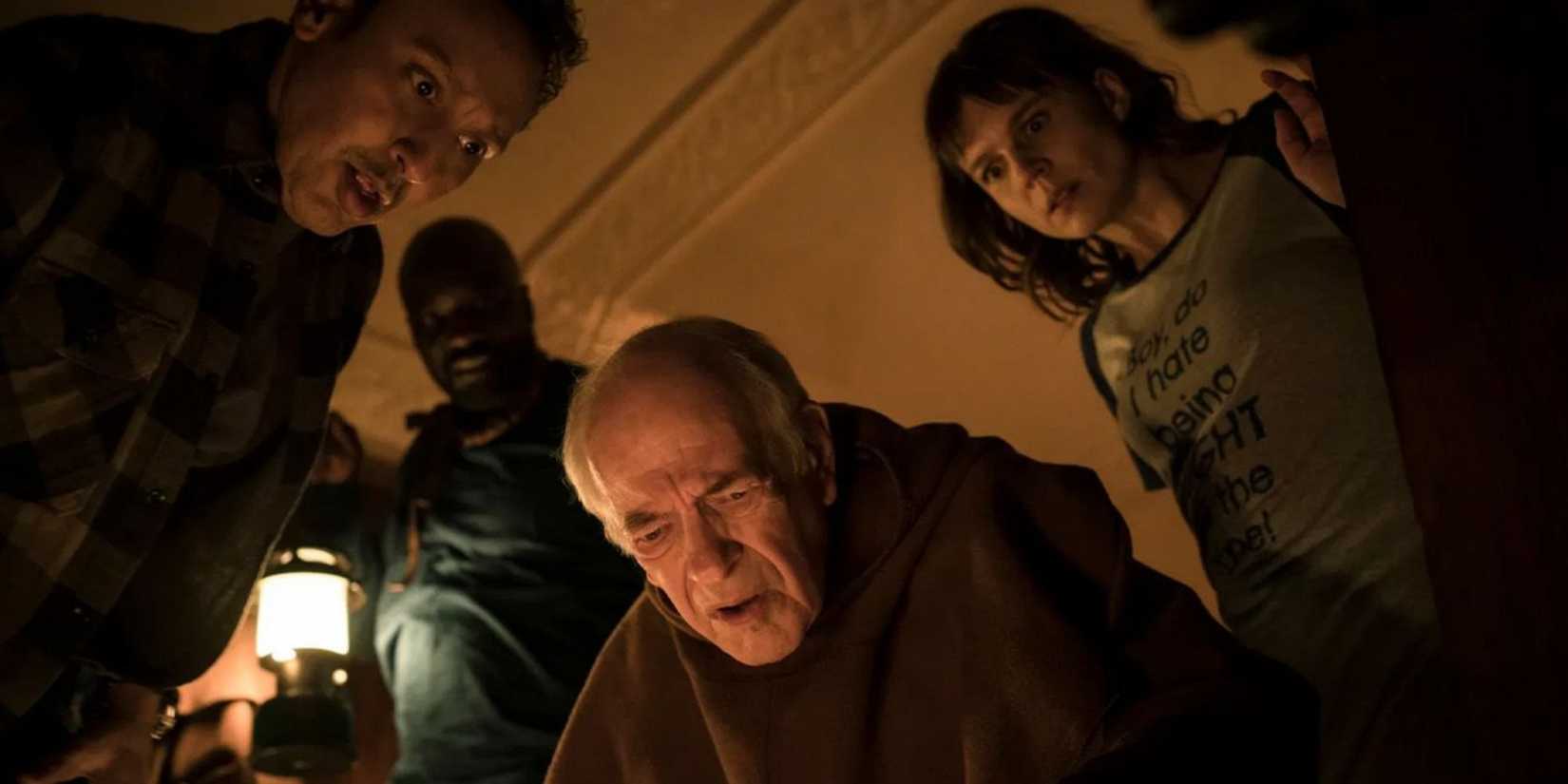 Dr. Kristen Bouchard (Katja Herbers), Ben Shakir (Aasif Mandvi), and David Acosta (Mike Colter) looking down at something in Evil Season 2, Episode 7 "S Is For Silence"