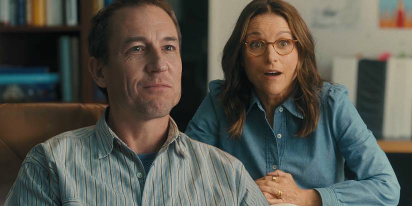 Beth (Julia Louis-Dreyfus) sits behind Don (Tobias Menzies) and looks surprised in You Hurt My Feelings.