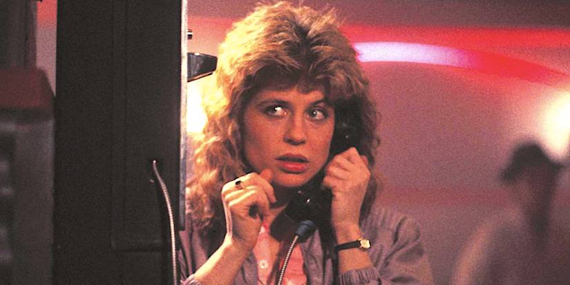 Linda Hamilton's Sarah Connor stands by a phone in The Terminator 1984