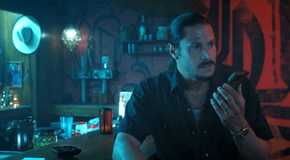 Jimenez (Alex Meraz) talking on the phone while sitting in a dim bar in Landman season 1, episode 9