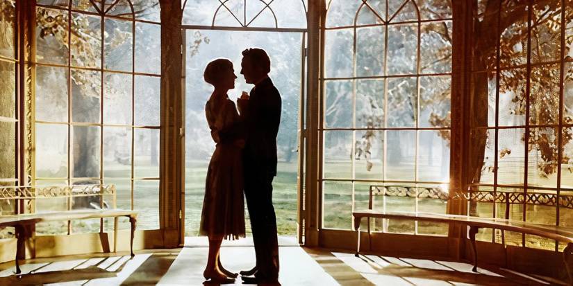 Maria (Julie Andrews) and Captain von Trapp (Christopher Plummer) holding each other closely in The Sound of Music