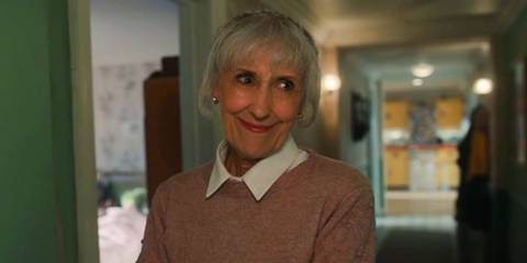 Mrs Flood smiling ominously while in Ruby's flat in Doctor Who.