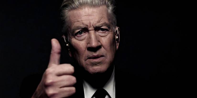 Gordon Cole (Lynch) gives a thumbs up from the shadows. 