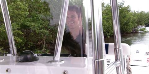Dexter Morgan (Michael C. Hall) piloting the Slice of Life, his boat, in Dexter season 1, episode 1