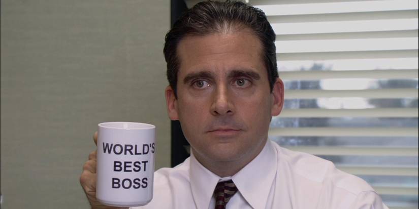 Steve Carell as Michael Scott holding up his World's Best Boss mug in The Office pilot.