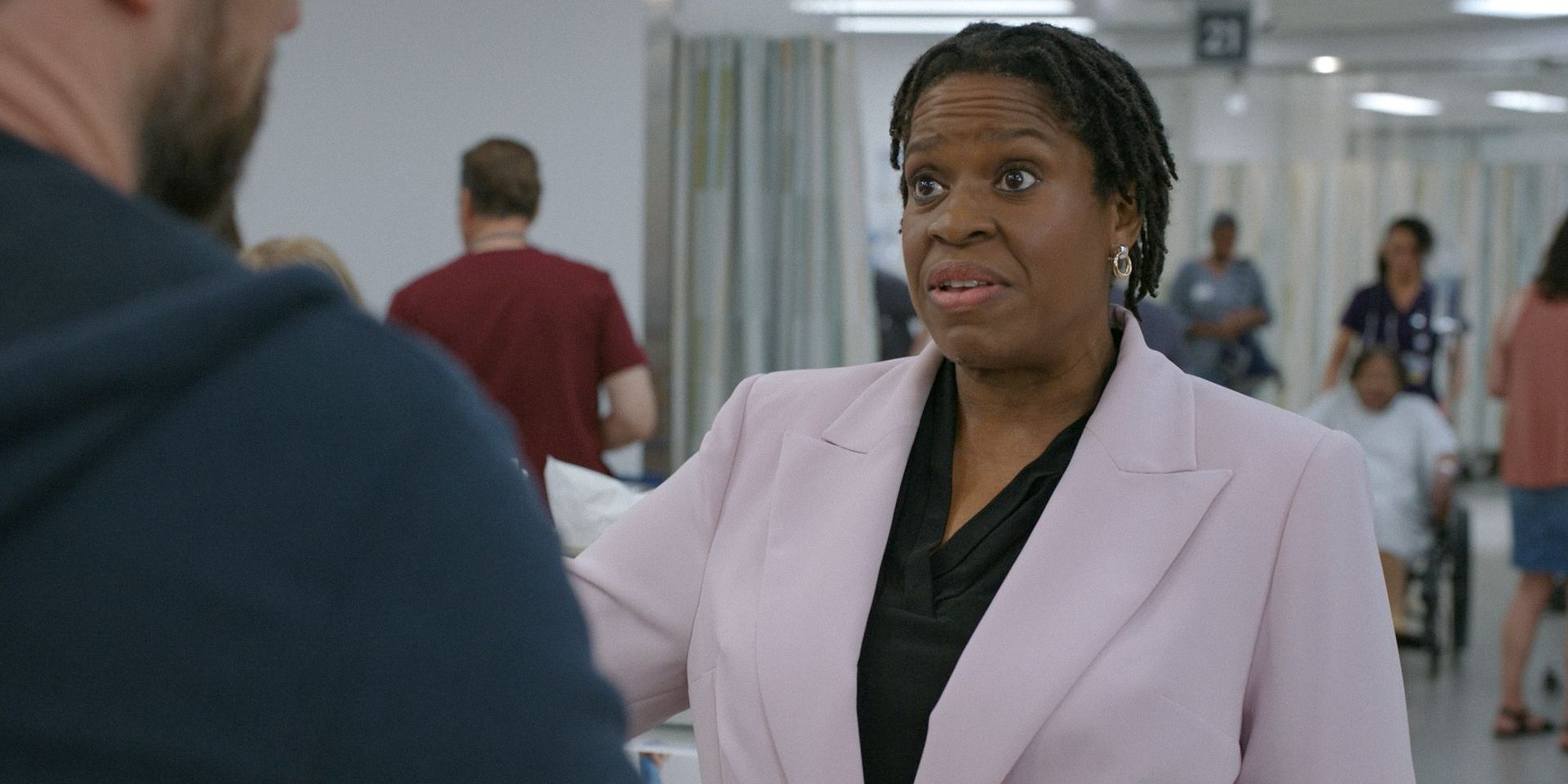 Gloria (Michael Hyatt) the hospital administrator looking annoyed in The Pitt Season 1 Ep 1