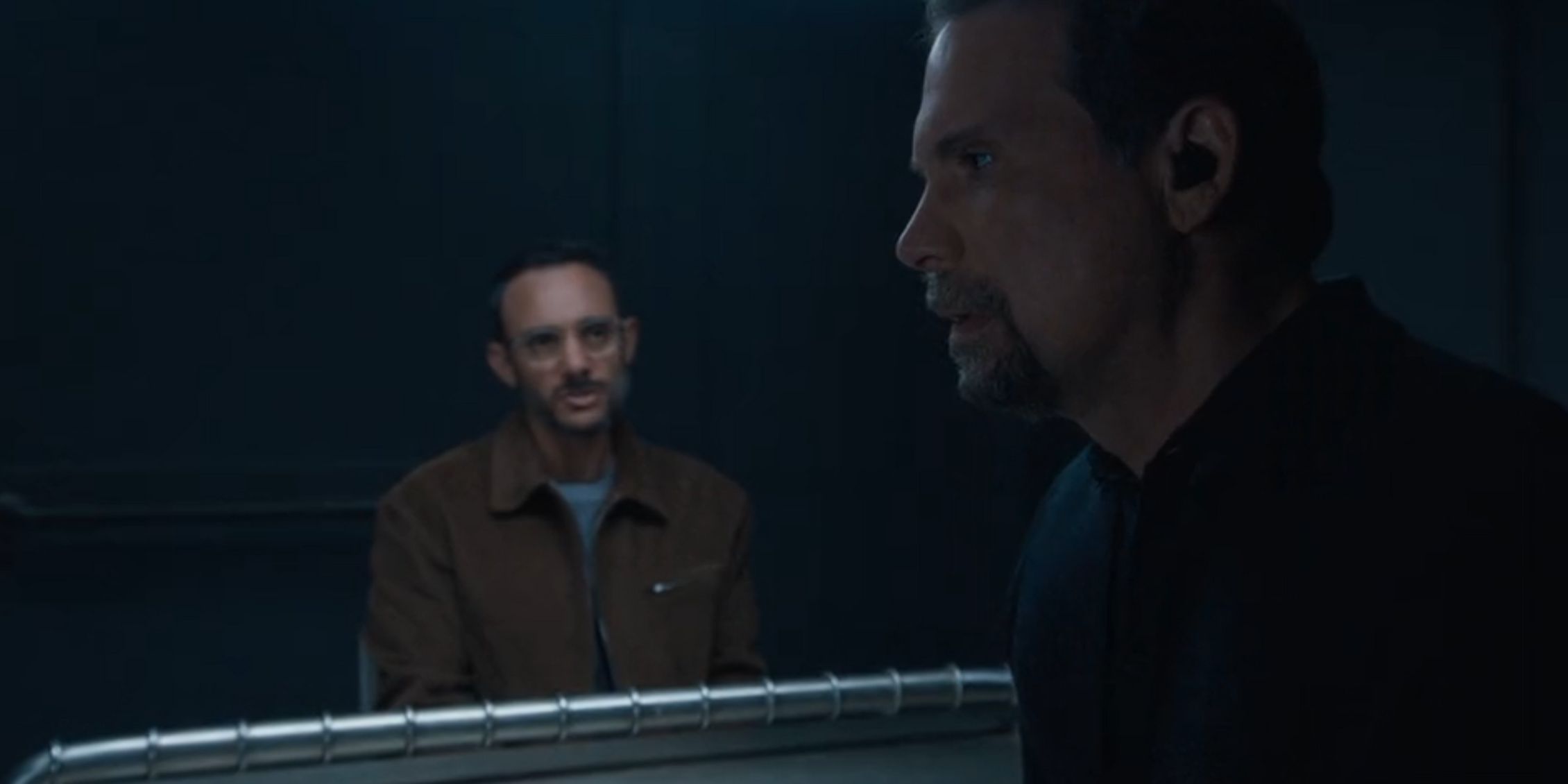 FBI Jubal standing and looking upset while Faheem sits at the interrogation table