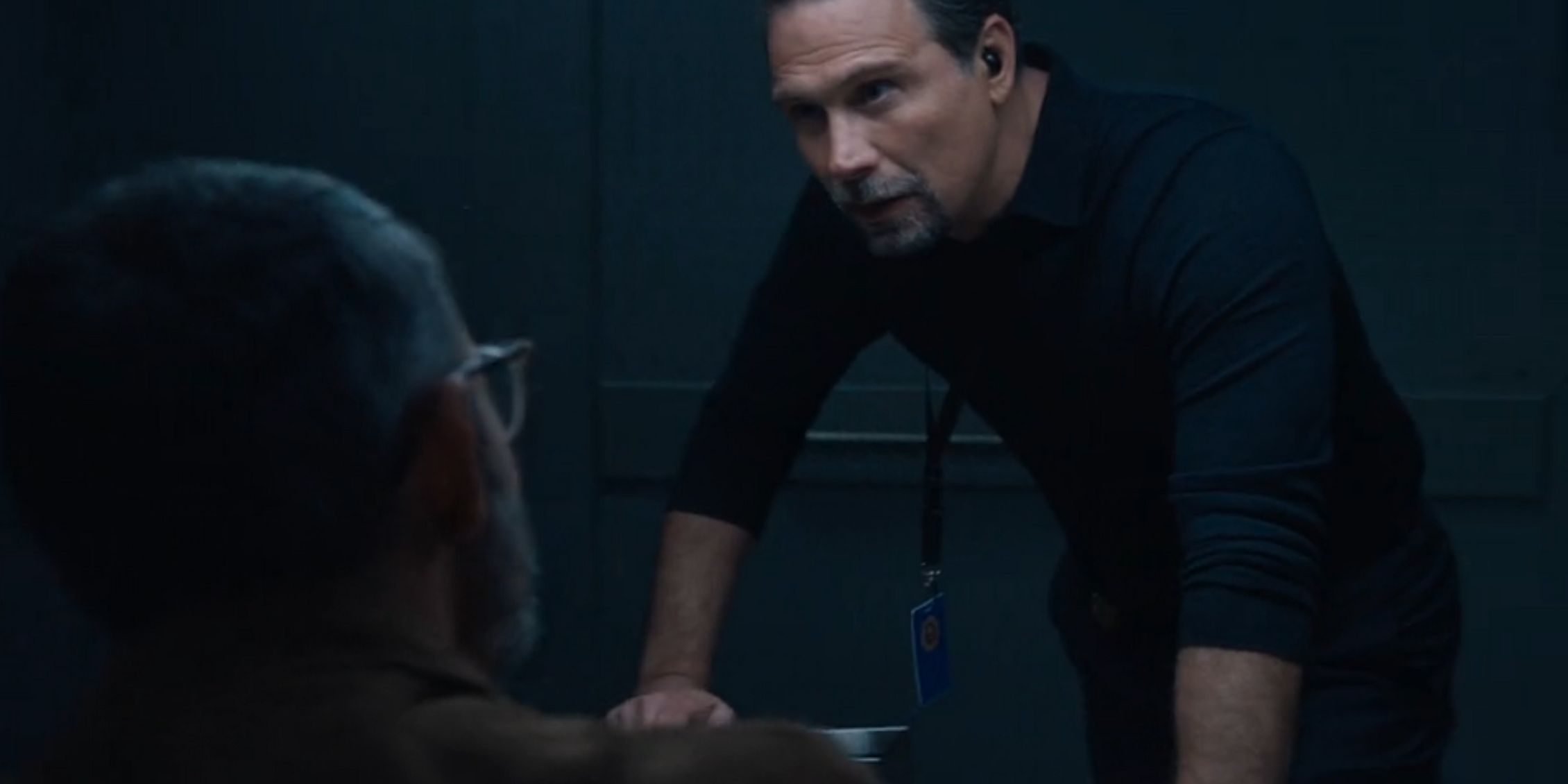 FBI Jubal leaning over the interrogation table looking Faheem in the eye