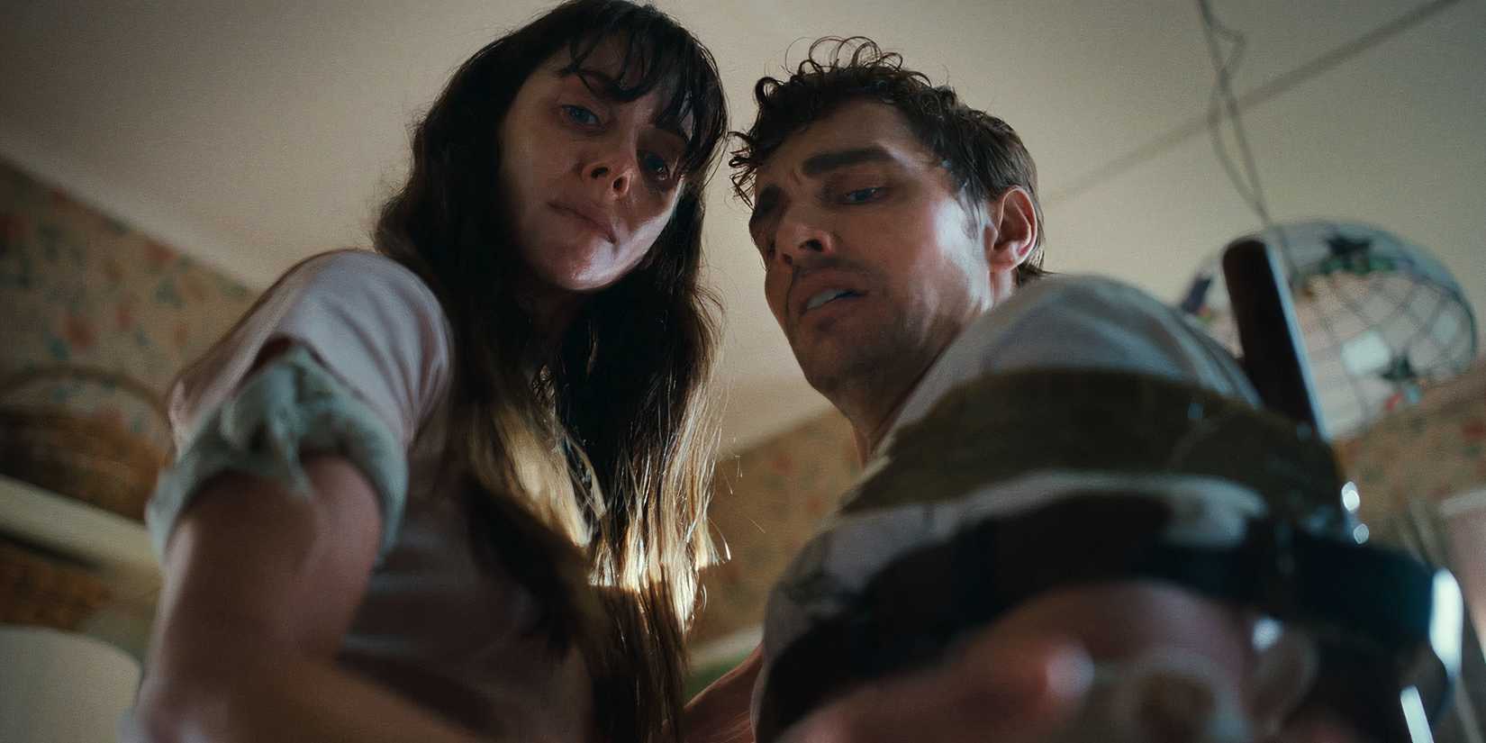 Элисон Брай и Дэйв Франко смотрят на свои руки в хоррор-фильме "Together"