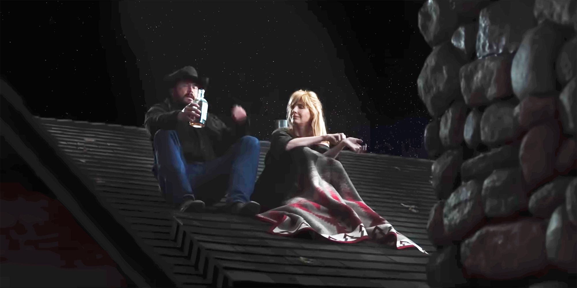 Beth and Rip sitting on the roof in Yellowstone