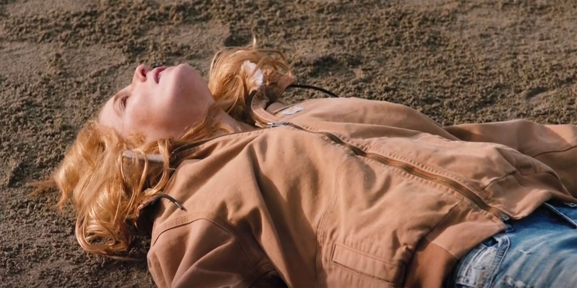 Beth lays in the fdirt and looks up at the sky