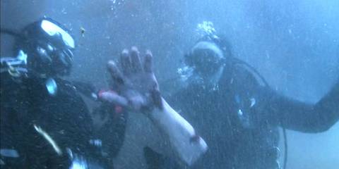 Two scuba divers unearth a severed arm in Dexter season 2, episode 1