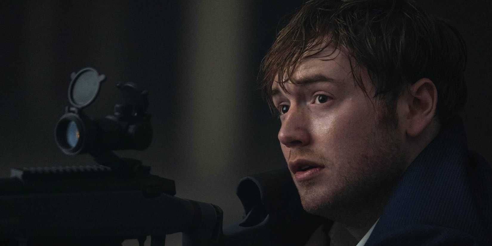 Cooper Hoffman with gun in Old Guy looking scared towards the audience 