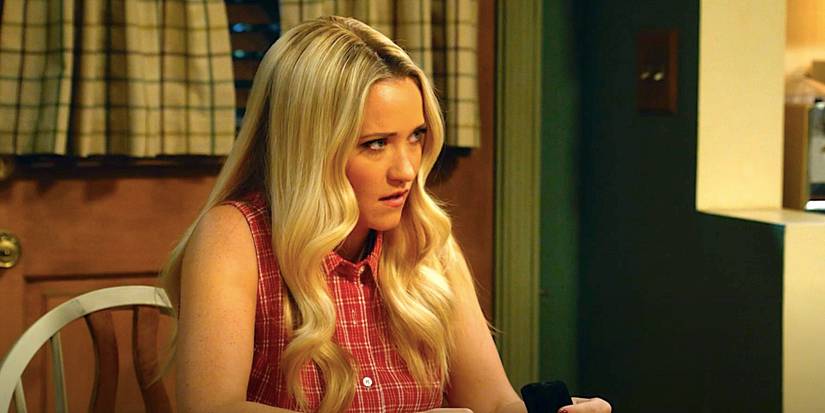 Emily Osment's Mandy sits at a kitchen table looking shocked in Georgie & Mandy's First Marriage