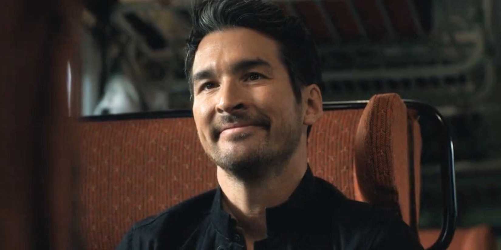 FBI International Booth sitting on a train and smiling