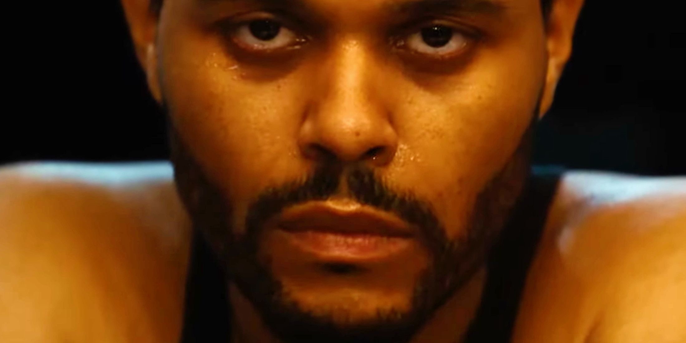 Hurry Up Tomorrow The Weeknd staring into camera 