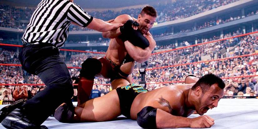 Ken Shamrock with an ankle lock on the Rock in a wwe ring