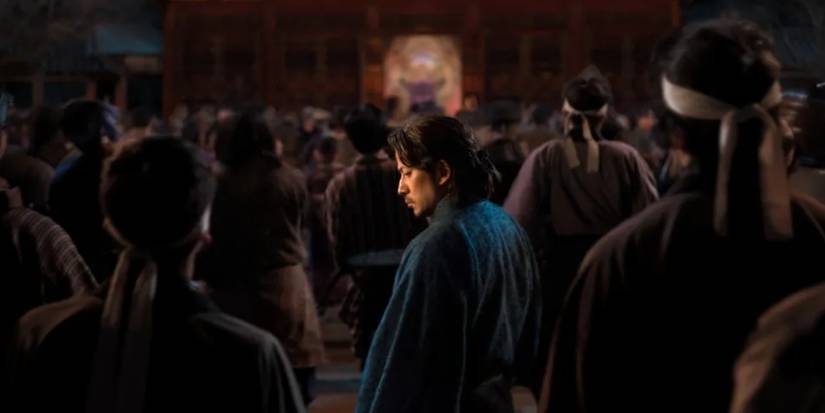 Man in blue looking over his should in Last Samurai Standing