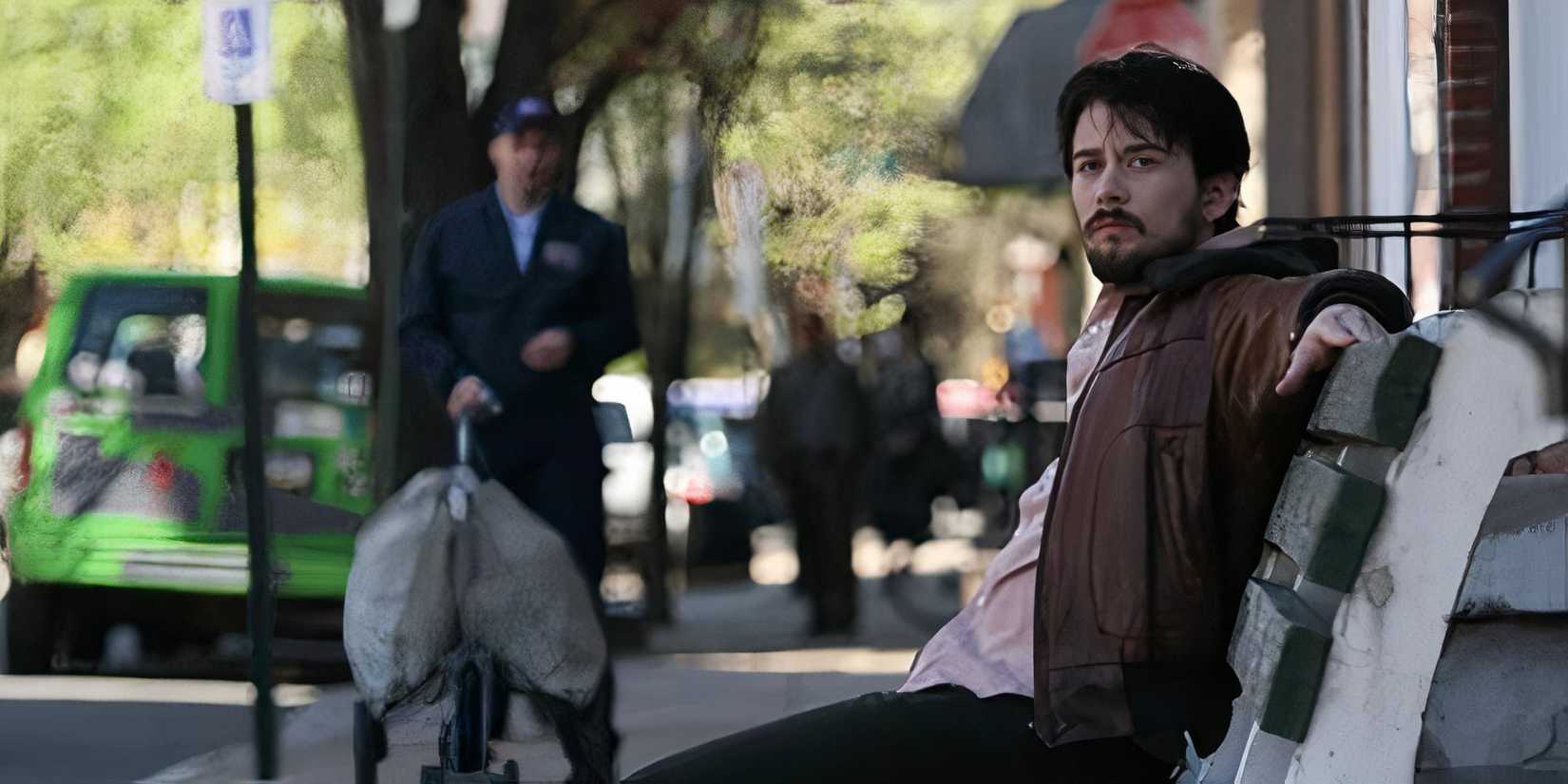 The Cast Of New Horror Movie Touch Me Explain Their Surprisingly Emotional Film About A Sexy Alien 2 Lou Taylor Pucci sitting on a bench in The Answer Man