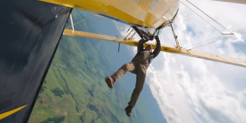 Tom Cruise hanging from a plane in Mission Impossible The Final Reckoning