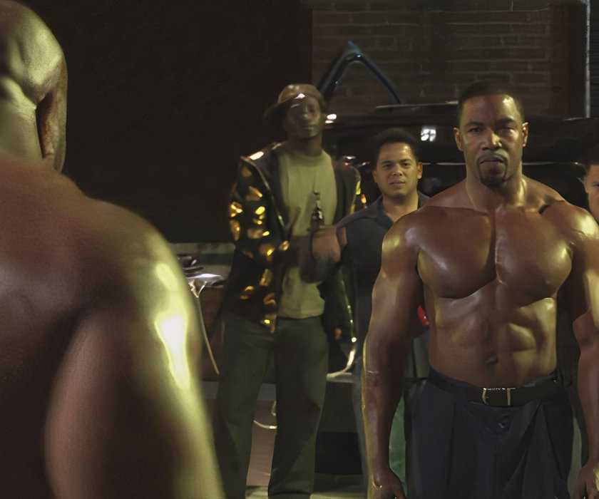 Michael Jai White stands across an opponent in Blood and Bone.