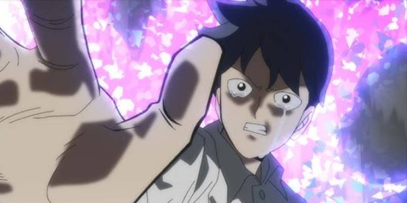 Mob Psycho 100's Ritsu crying with his hand held out as psychic energy surrounds him.