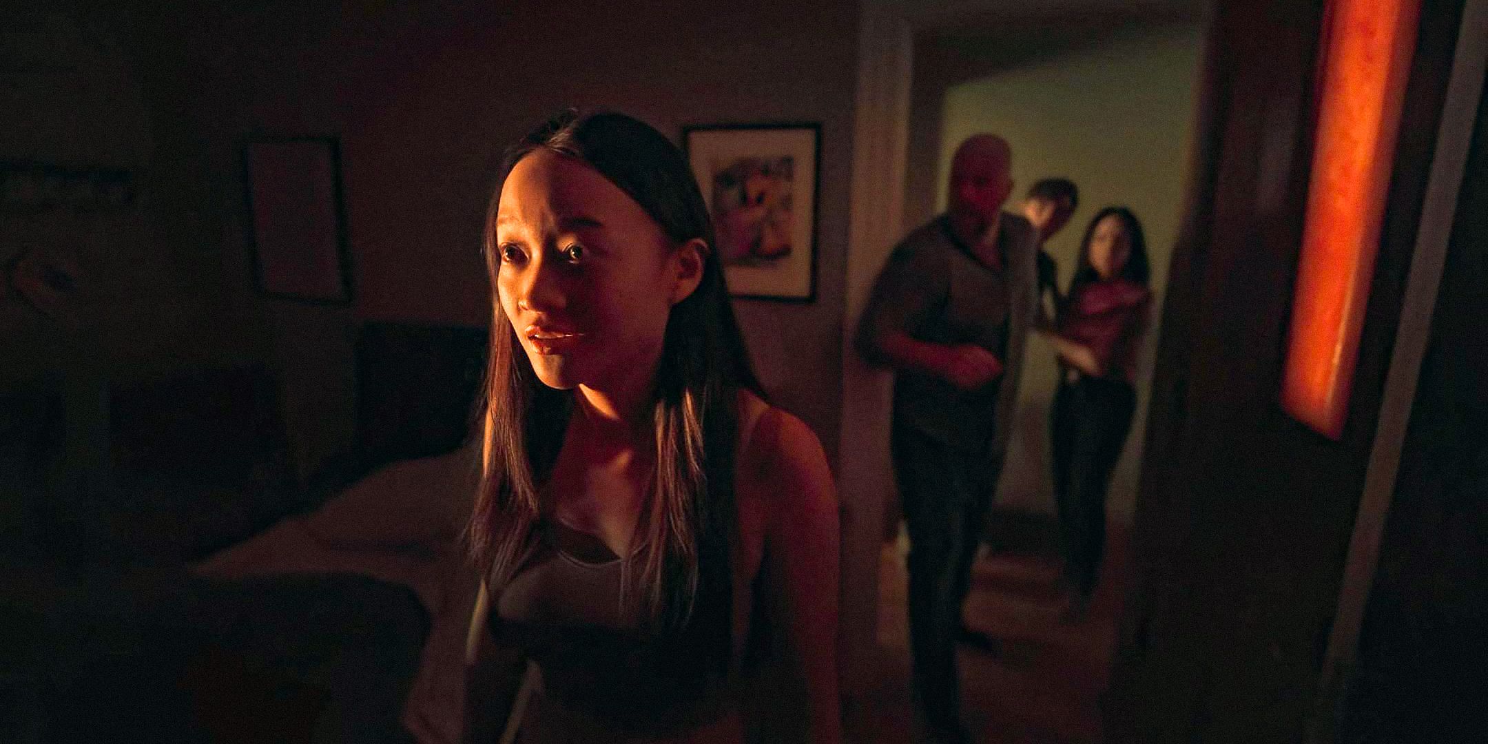 Chloe (Callina Liang) stands frozen while her family tries to help her in Presence