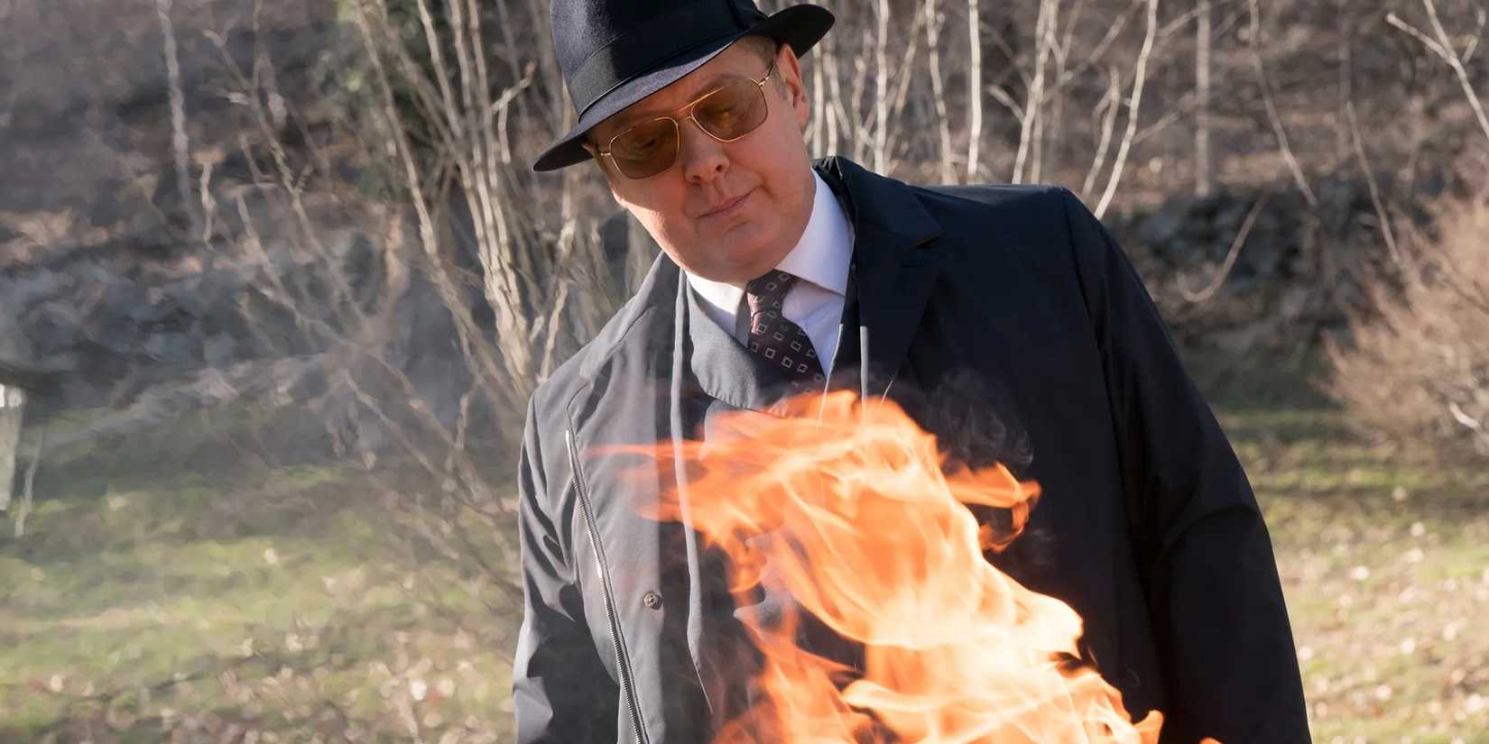 James Spader as Reddington watching the bones burn on a fire in The Blacklist season 5 finale. 
