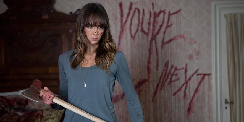 Sharni Vinson as Erin holding an axe in You're Next