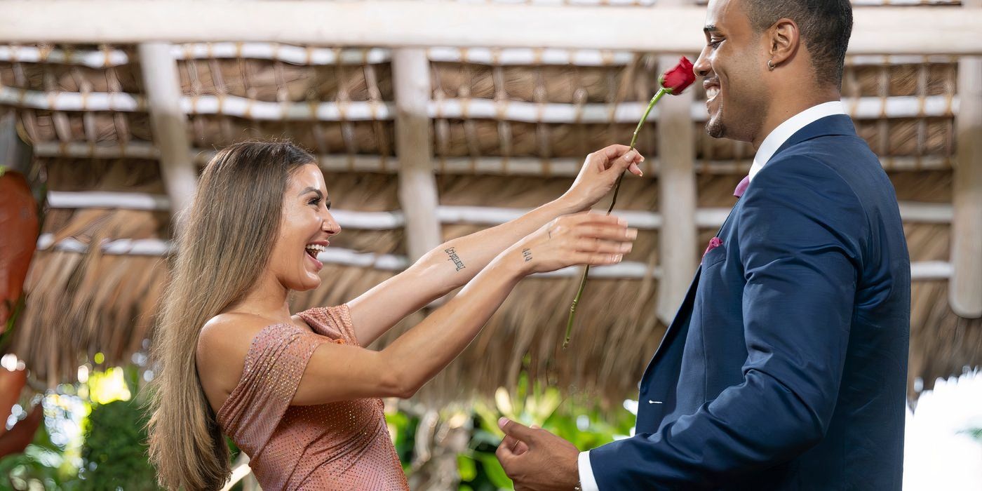 Juliana Pasquarosa and Grant Ellis reach to embrace each other on The Bachelor