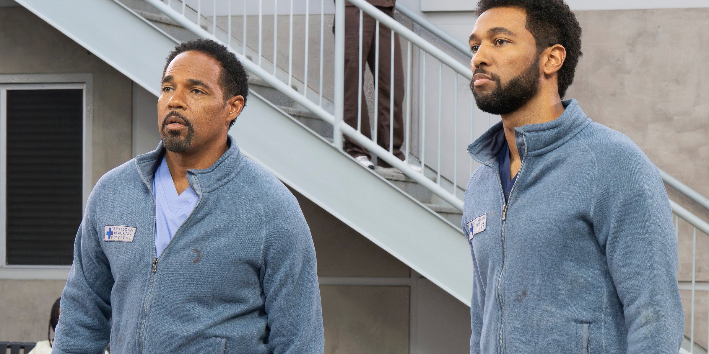 Ben and Winston stand next to each other with serious expressions in Grey's Anatomy season 21 episode 10