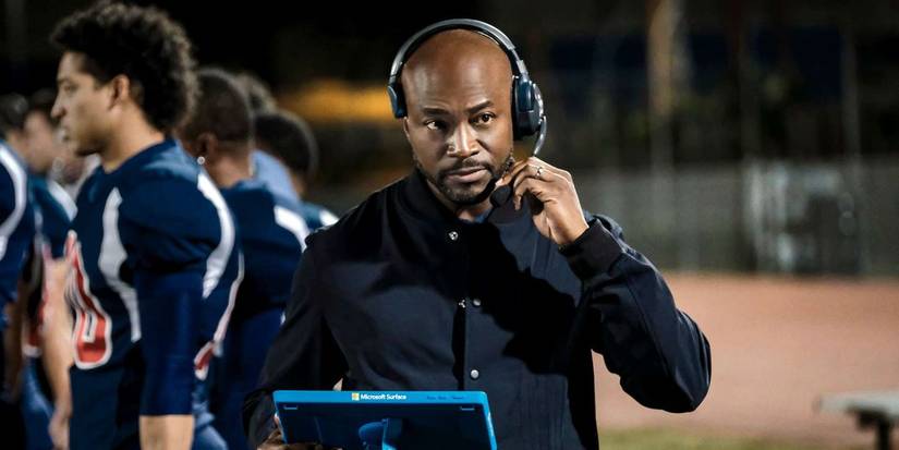 billy baker taye diggs talking into a headset during a football game in all american