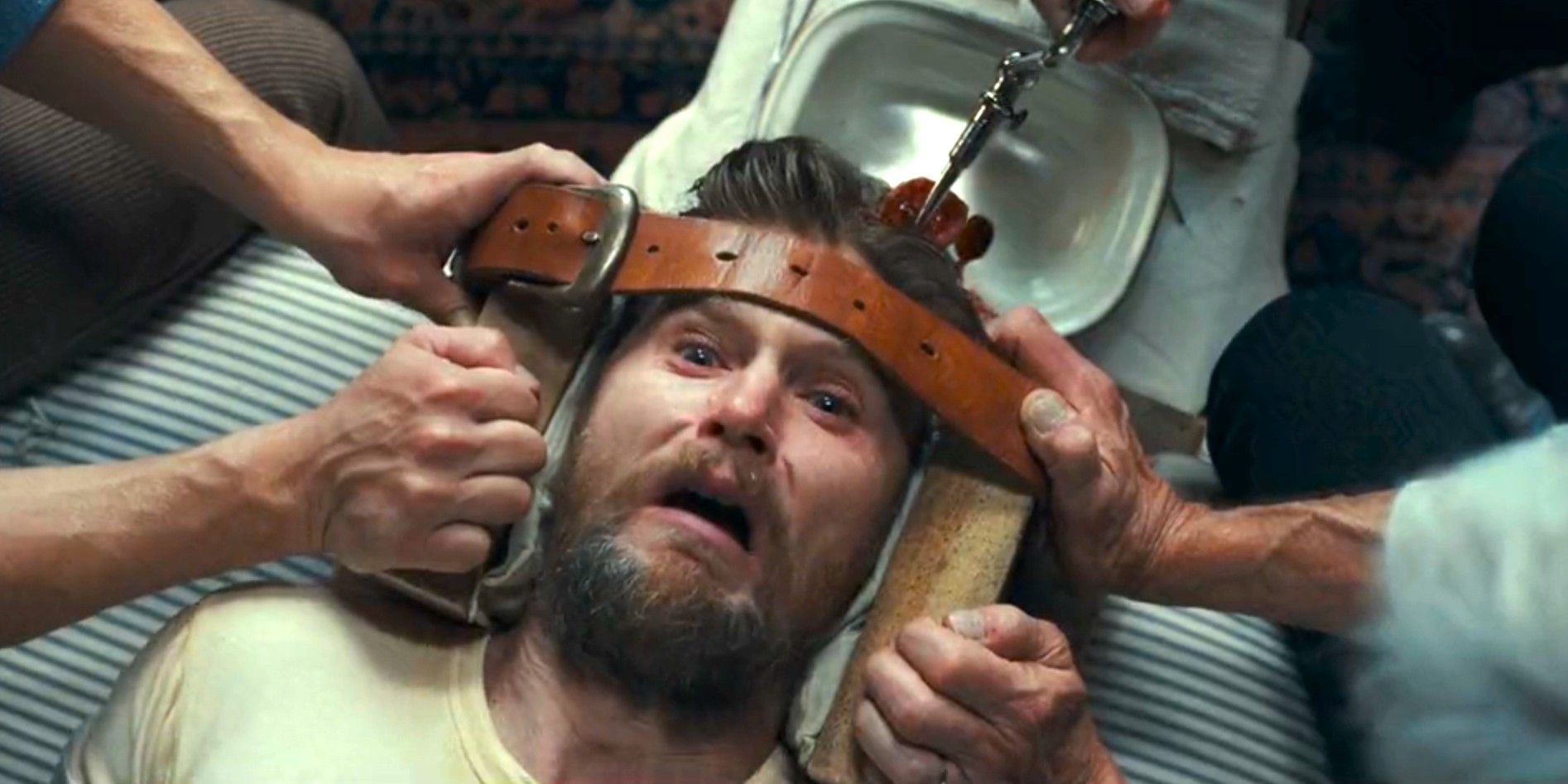 Zane Davis (Brian Geraghty) screams in pain as two men hold his head in place and a third drills into his skull in 1923 season 2, episode 4