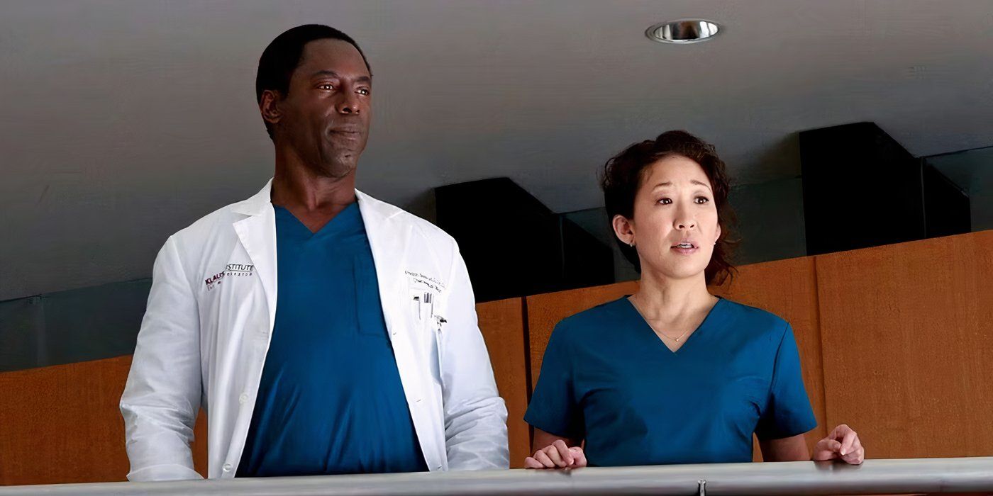 Cristina and Burke standing on a balcony in Grey's Anatomy