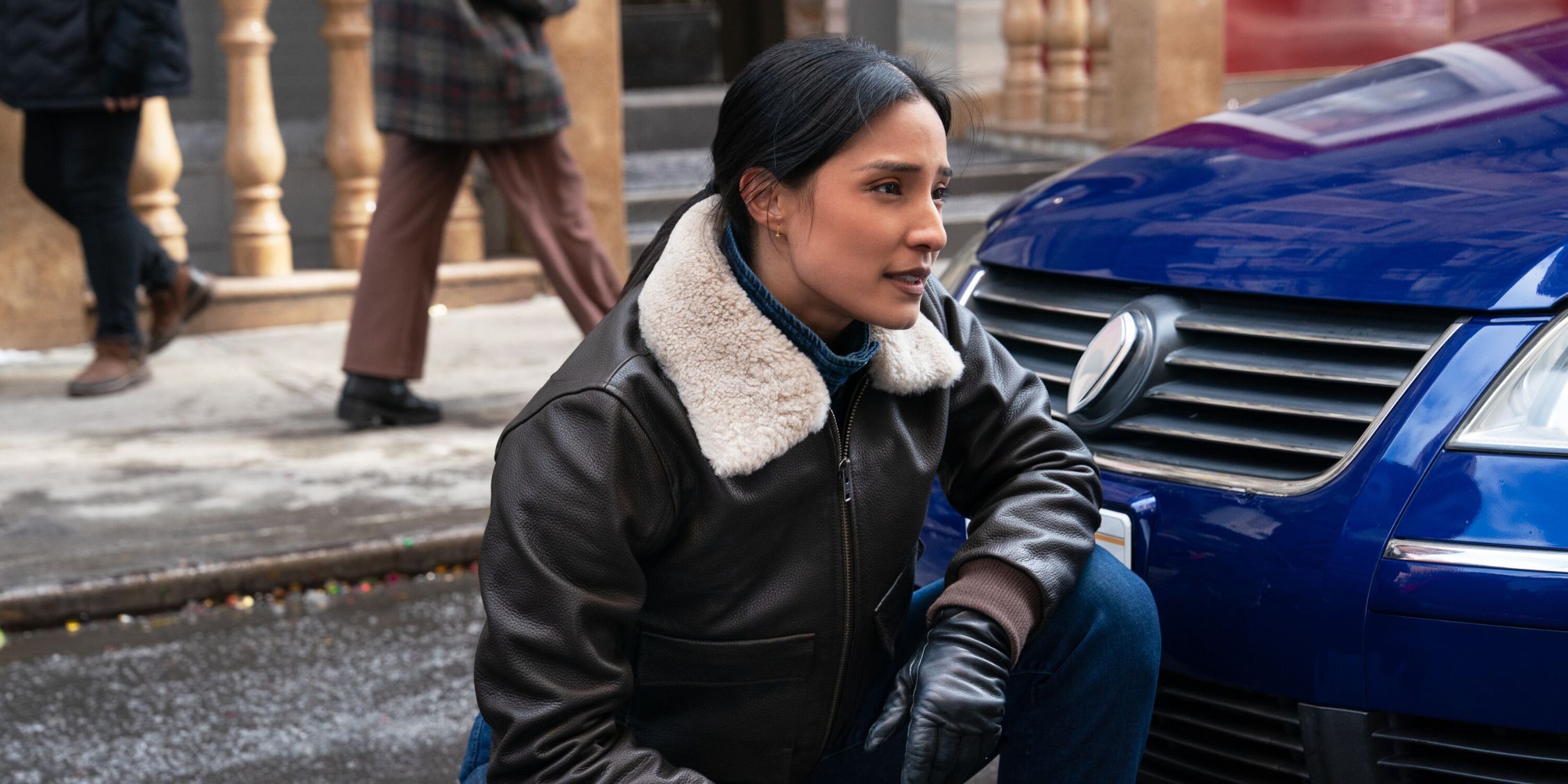 FBI Emily Alabi as Dani Rhodes standing by a police car