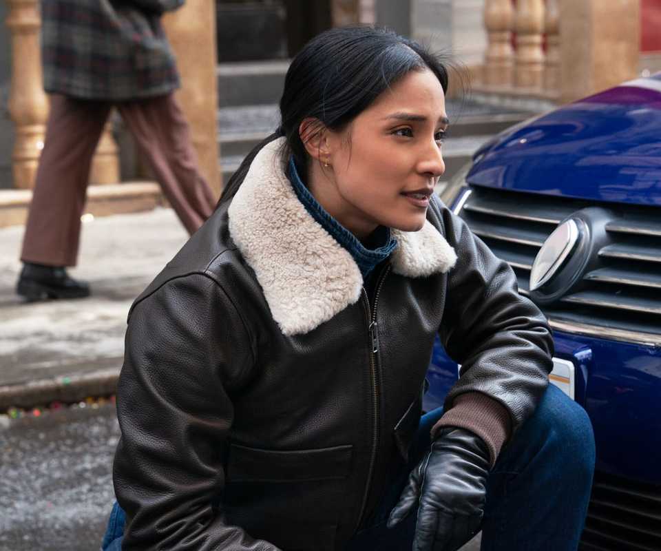 FBI Emily Alabi as Dani Rhodes standing by a police car