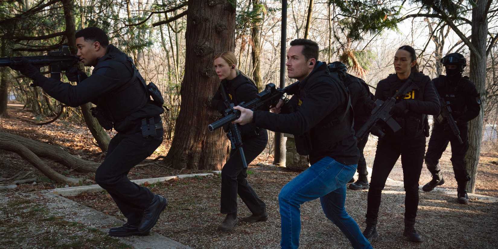 FBI International the team sneaking through the woods with large guns out