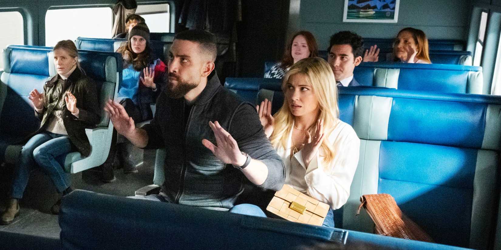 FBI OA and Gemma sitting on a train with their hands up looking nervous