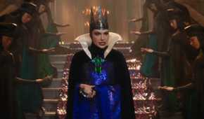 Gal Gadot as the Evil Queen walks down the stairs in Snow White 2025