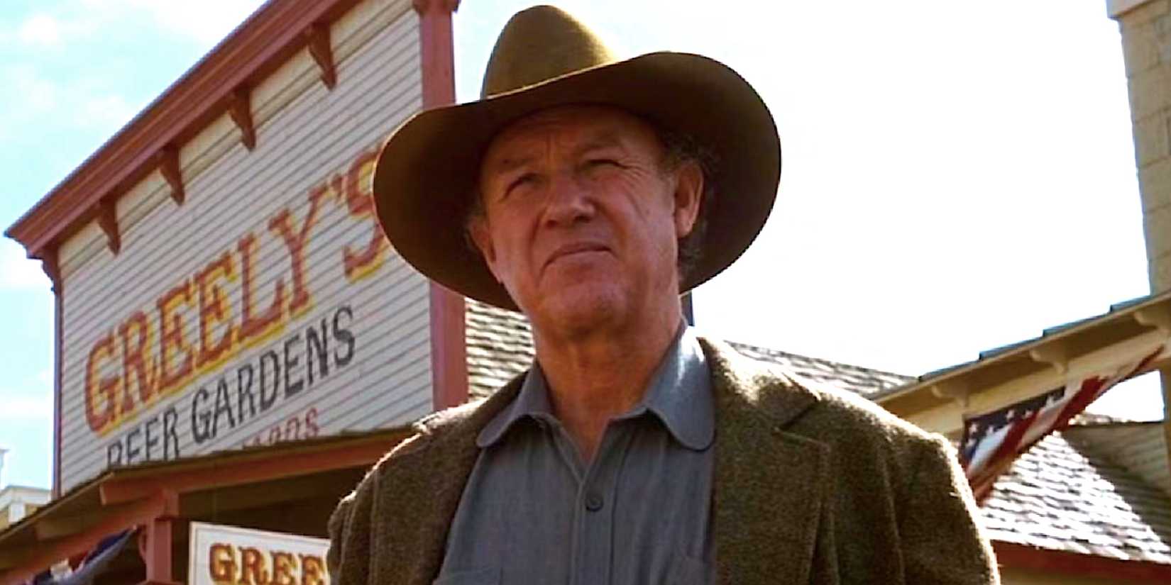 Gene Hackman's Little Bill Dagget stands outside a general store in Unforgiven